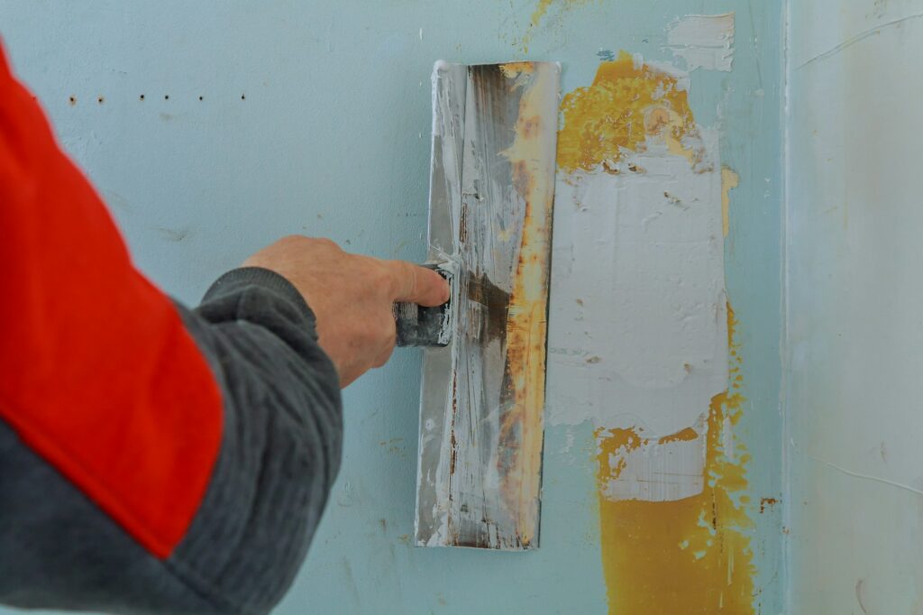 Male builder makes repairs in the apartment