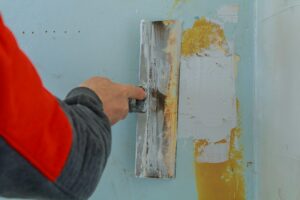 Male builder makes repairs in the apartment